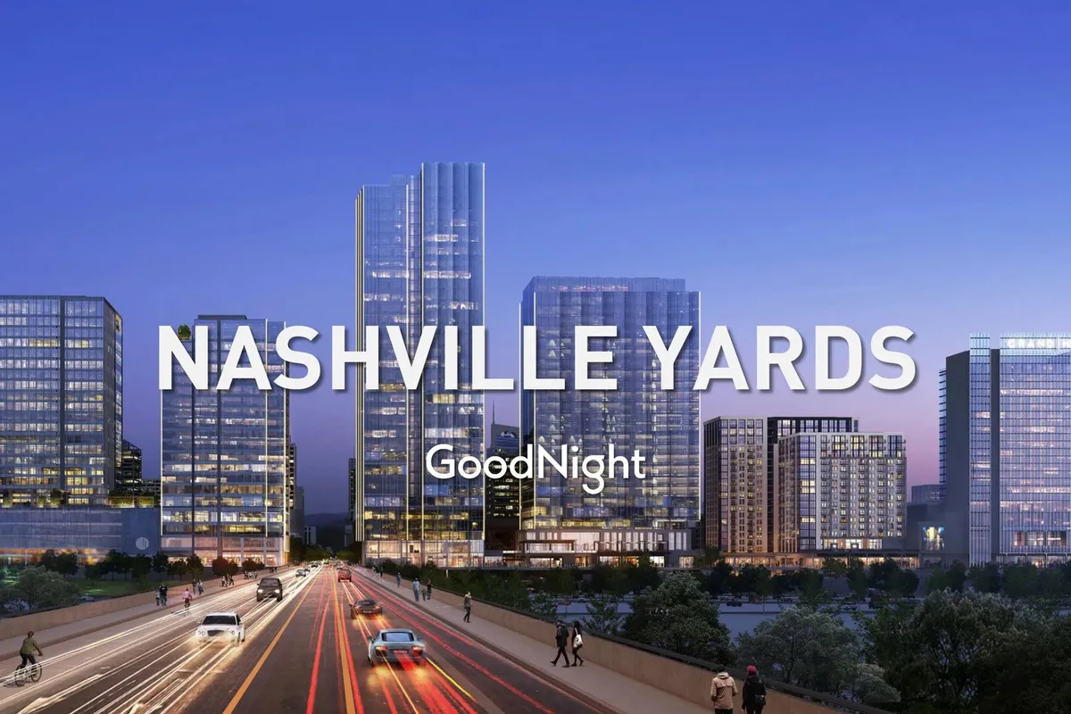 An energetic street-level exterior scene showcasing Nashville's skyscrapers, illuminated city lights, pedestrians, and a lively road at night. The dynamic atmosphere reflects the excitement of exploring local nightlife, with hints of nearby restaurants and gathering places.