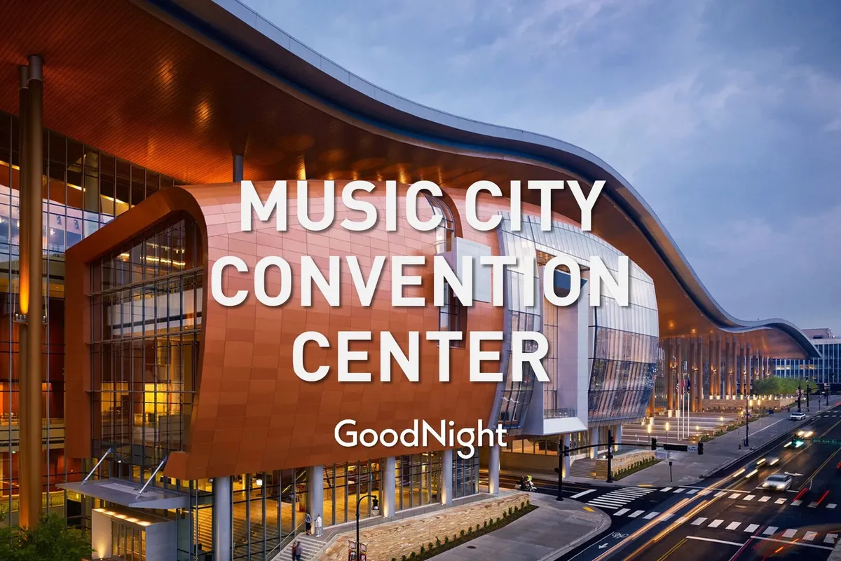 An exterior view of a modern building, featuring unique architectural design, vibrant colors, and illuminated windows. The scene suggests energy and activity, hinting at the building's function as a hub for conferences, exhibitions, and social gatherings.