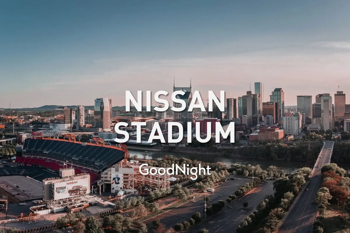 A panoramic city view featuring Nissan Stadium, the downtown Nashville skyline, and the river in the foreground. The scene combines energy with calm, suggesting both the vibrancy of urban life and opportunities for relaxation.