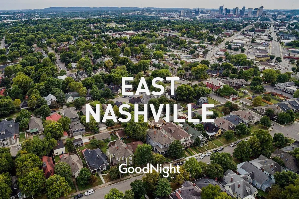 A friendly neighborhood scene with lush green trees, residential homes, and a distant view of the city skyline. The inviting atmosphere suggests a vibrant and welcoming community perfect for families.